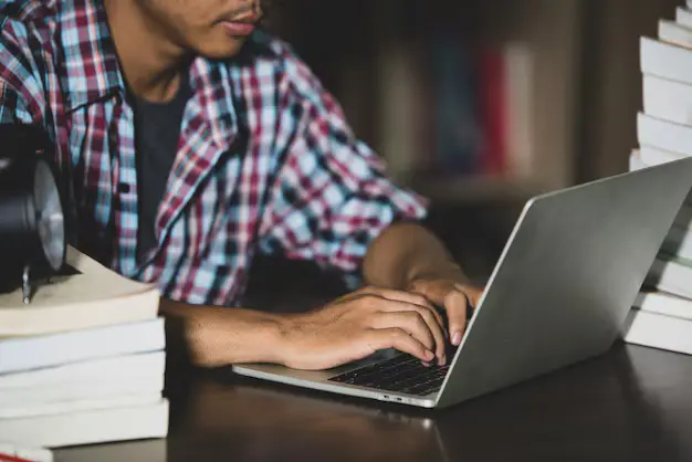 Students checking college info on laptop